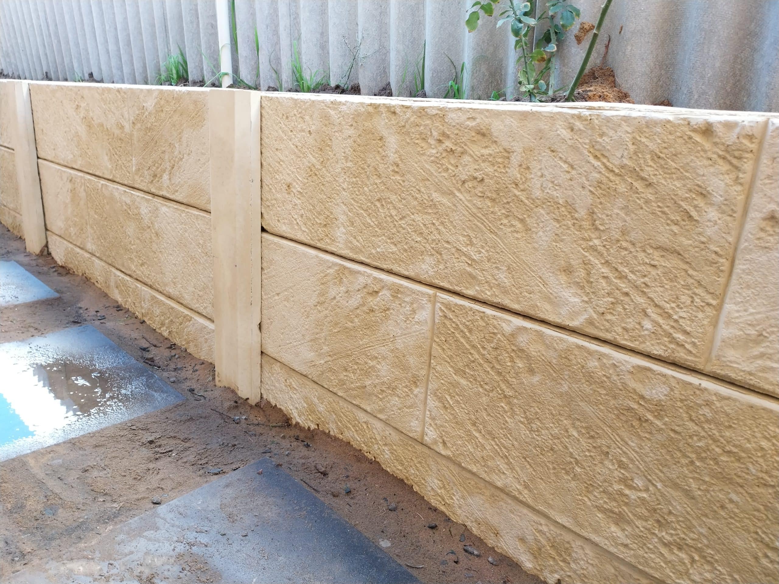 limestone look panel and posts retaining with concrete posts